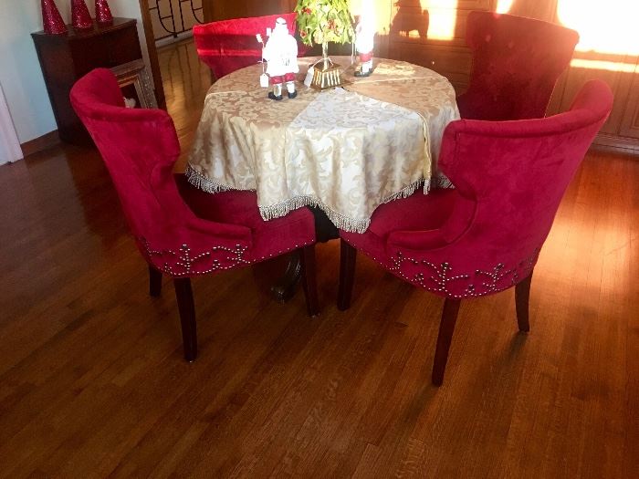 Red velvet dining or game table chairs with fancy nailhead trim detail 