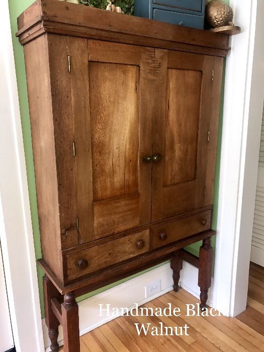 Hand crafted Antique black walnut cabinet. Located in the house. (Dimensions: 37.5" wide, 11" deep and 65" tall)
