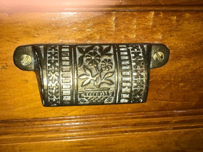 Original brass drawer pulls on antique art cabinet