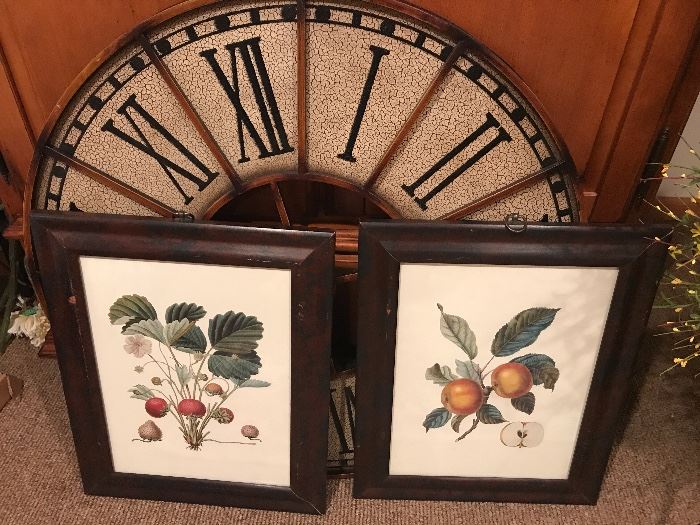 Framed artwork prints and a clock face