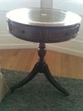 Lovely antique leather inlaid 20"diameter drum table measuring 25"h.