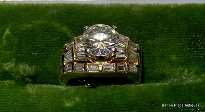 18 kt Gold Ring, brilliant cut 2.01 carat diamond in center, 10 baguette diamonds .60 total carat weight.  Size 5 , Clarity VS-2, color grade G, 