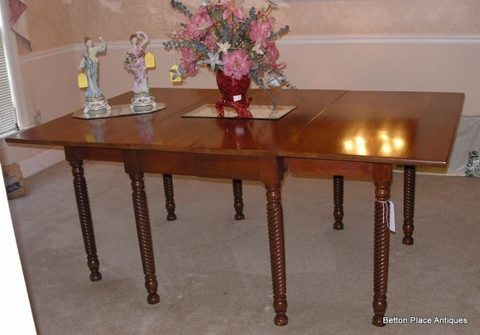 Another view of the Antique Cherry Gateleg Dropside Dining Table with one extension.