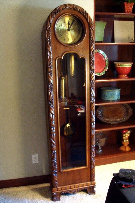 Craftsman period oak grand father clock with hand carved decoration needing repairs.