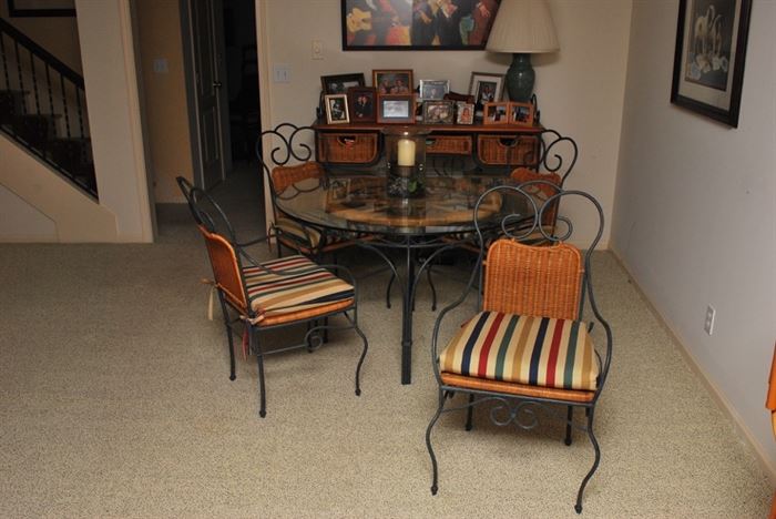 Dining table with glass top, wicker and wrought iron chairs