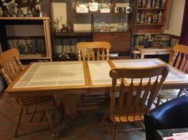 Tile top kitchen table with leaf and four chairs.