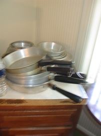 assorted aluminum and stainless pots and pans