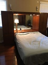 Thomasville vintage Mid Century Modern Queen bed with overhead lighting, concealed pull out night stands, double doors on each side with shelving.  mattress by Beauty Rest 