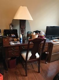 Desk, African Lamp. Chair. Office supplies. File cabinets. 