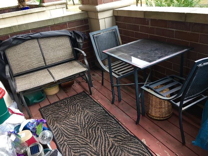 Patio furniture. Table and chairs. Glider. Flower pots. 