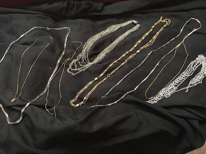 various collections of gold and silver chains
