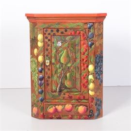 Vintage Hand Painted Wall Mount Corner Cabinet by H.E. Kirstel: A vintage hand-painted wall mount corner cabinet by H.E. Kirstel. This triangular top piece features a single cabinet door to the front with a hand-painted fruit motif depicting pears, peaches, and berries. The cabinet door opens to two petite shelves. The verso includes hardware for hanging purposes. This piece is marked “H.E. Kirstel” in black paint.