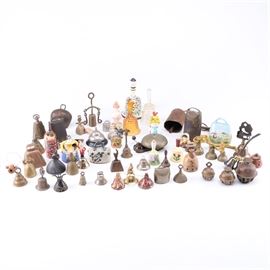 Assortment of Bells: An assortment of bells.The collection includes approximately sixty-four hand bells, service bells, cow bells, and more. Primary materials: metal, ceramic, and glass.