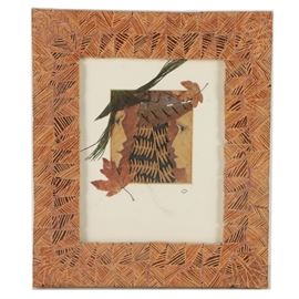 Linda Keohane Mixed Media Collage with Leaves and Feathers: A mixed media collage on paper by listed artist, Linda Keohane. The work is comprised of acrylic paint, dried leaves and feathers, and depicts the heads of two human figures who are facing each other. It is signed to the lower right corner, matted in white and presented behind glass in a textured wooden frame with a string for hanging to the verso. To the verso is a hand-inscribed note giving information on the materials and frame, as well as the artist’s signature and a label from Two Lanes Gallery.