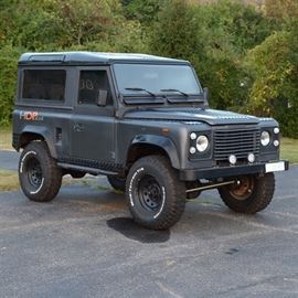 1990 Land Rover Defender: A restored 1990 2-door Land Rover Defender; VIN is SALLDVAF8HA459678 and odometer reads 393324 km (244,400 mi). Exterior has satin gun metal dark gray finish with black painted stainless steel diamond tread plate accents, and features include left-hand drive diesel engine with four jump seats to the rear cab, and a rebuilt 2.5 liter inline 4 cylinder, diesel 5-speed manual transmission. Note additional pictures added from time period during the restoration.