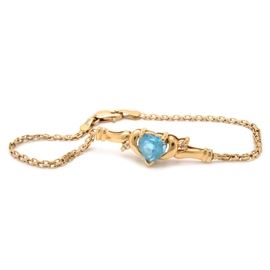 14K Yellow Gold Blue Topaz Bracelet: A 14K yellow gold blue topaz bracelet, with a heart-shaped center stone.
