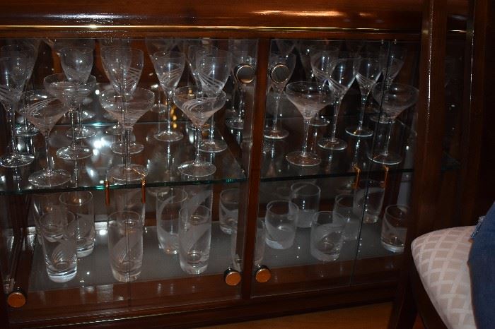 Just a few of the 80+ pcs of Lenox "Windswept" Crystal Stemware that includes: 11 Iced Tea Glasses, 15 Water Goblets, 15 Wine Goblets, 10 Fluted Champagne, 10 Martini, 14 Double Old Fashioned, 3 Single Light Candle Sticks, Pair of Salt & Pepper, Sugar & Creamer, plus Platter and Vases! 