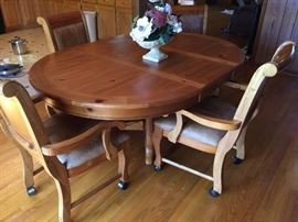 #45 Pine table w 1 leaf, 65x48x30.5 w/4 chairs on wheels $225.00