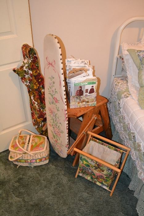 Vintage sewing patterns along with sewing baskets and an adorable vintage folding ironing board. 