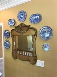 distressed gilt mirror with assorted Delft plates