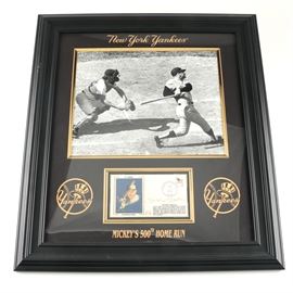 Mickey Mantle Autographed Postcard in Framed Photo Display: A framed display featuring a Mickey Mantle autographed postcard. This National Baseball Hall of Fame postcard featuring Mickey Mantle is hand-signed “Mickey Mantle” and postmarked from Cooperstown, New York on June 12, 1979. The postcard is framed with a black-and-white photo of Mantle at bat; gold tone text on the mat reads “New York Yankees” and “Mickey’s 500th Home Run”.
