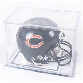 Mike Singletary Signed Football Helmet: A former NFL Chicago Bears linebacker Mike Singletary signed helmet. Singletary was drafted by the Chicago Bears in 1981 and was known as “the heart of the defense” and earned the nickname “Samurai Mike” for the intensity he displayed on the field and he was inducted into the Pro Football Hall of Fame in 1998. He was one of the many stars on the Super Bowl XX winning squad in 1985. The helmet features a signature in silver ink and is stored within a plastic display case. It includes a Certificate of Authenticity from Allstarlineup.