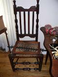 AMERICAN WILLIAM AND MARY RUSH-SEAT SIDE CHAIR . Shaped crest rail above four simple vertical slats; baluster and cylinder-turned stiles with crown-shaped finials. Ring-turned straight cylindrical legs with double turned front stretcher; sausage side stretchers. H: 44"; Seat H: 17"; D: 15"; W: 20 1/2"