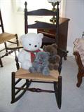 Queen Anne American Rocking Chair with whicker seating, slat back. Dark finish; both rocking chair arms have been repaired with square pegs; H: 42"; Seat H: 14 "; D: 17"; W: 20"