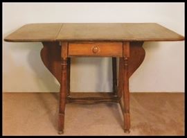 Vintage Early American drop leaf table 50 inches by 36 inches when open and 21 inches wide when leaves are down