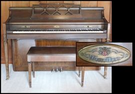 Wurlitzer spinet  walnut finish piano with bench. 24 inches by 56 inches by 40 inches high