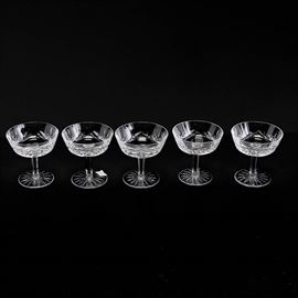 Set of Six Waterford Crystal "Lismore" Champagne Tall Sherbet Goblets: A set of five crystal champagne or tall sherbet goblets by Waterford in their most popular pattern, Lismore. They feature shallow by wide basins with short stems and round bases. To the underside of the bases, they are marked “Waterford”.