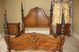 BEDROOM SUITE. 2 BEDSIDE TABLES AND ARMOIRE - BED IS KING SIZE. IRON AND WOOD POSTERS