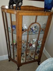 One of Two Curio Cabinets. These are filled with miniature figures and animals. Elephant on top and art glass. Rabbits, rabbits and more Rabbits. 