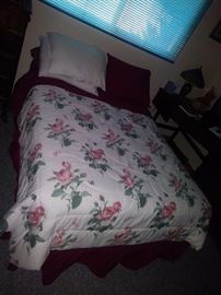 Bed with rose bedspread 