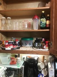 Spices in cupboard along with other cooking items