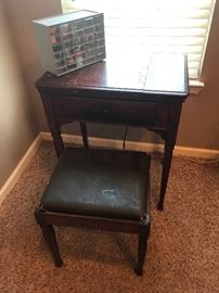 Sewing machine cabinet and stool; small box contains sewing items including thread