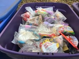 Tubs of McDonald's toys _ outside behind the house