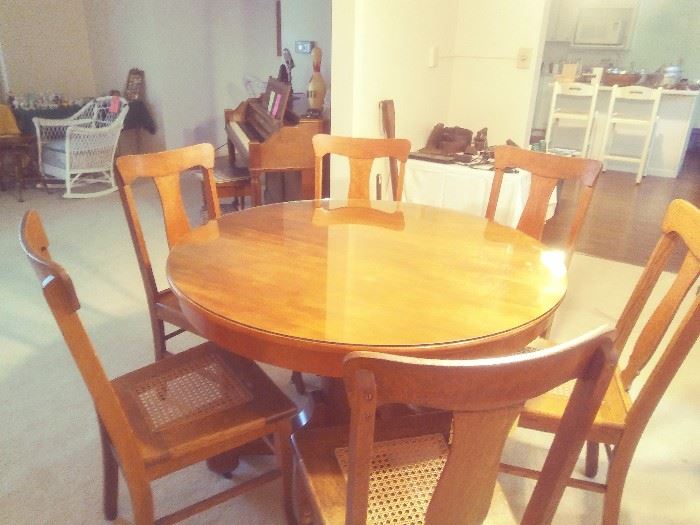 Expandable Dining Table & 6-Chairs with woven seat, table has 3-9"- leaves (not shown) expands from 45" Round to 45"x 73-1/2" Oval.