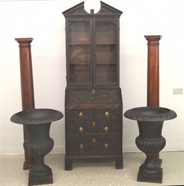 Carved  oak secretary, iron urns, oak columns 