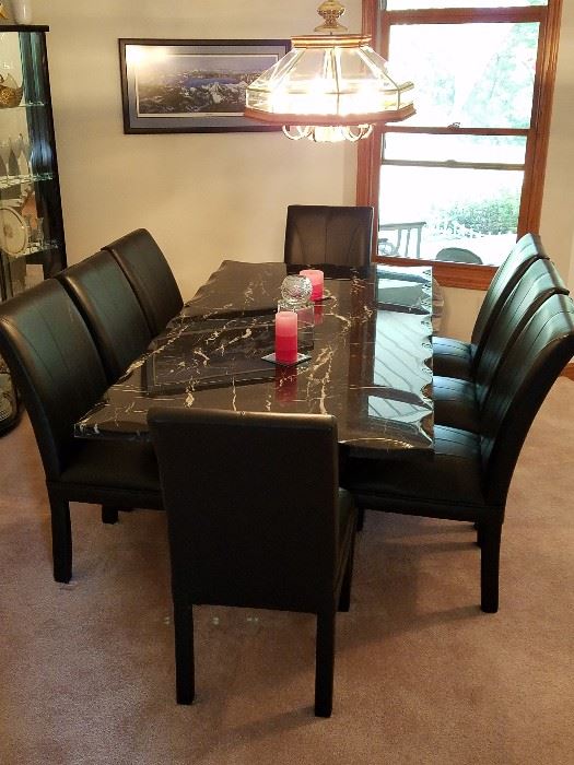 Solid Marble diningroom table & 8 leather chairs.