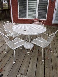 #70	White Wrought Iron Table 42" Diameter With 4 chairs	 $125.00 
