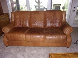 Buckskin leather roll armed living room set with Two Sofas/Couch, Chair, and Ottoman. Your family room will never feel better!