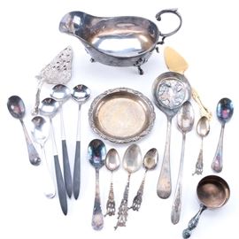 Silver Plate Flatware and Serveware with Towle: A group of silver plate flatware and serveware. There are seventeen pieces in total with a gravy boat, three teaspoons by Victor Silver Co., one tablespoon and three teaspoons with pierced handles, a pie server with a hollow handle, a gold-plated server with perforated edges and a hollow handle, a Sheffield serving spoon with perforations and an embossed bowl. Additionally, a Towle measuring cup is present with a hollow handle and an Italian bowl with embossed trim is included. There are four bar spoons and a teaspoon; one is made of silver plate and the others have stainless bodies with black handles.