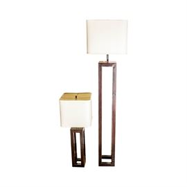 Coordinating Contemporary Floor and Table Lamps: A selection of coordinating contemporary floor and table lamps. The selection includes two metal lamps with a silver tone harp, cap finial and center pole that showcase a square shaped white lamp shade. Other features of the lights include a square metal vase cap and a rectangular shaped metal body with a black finish that stands on an open square shaped base.
