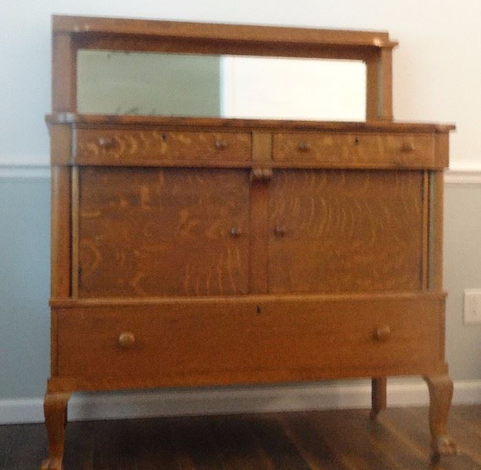 antique quarter sawn oak sideboard with beveled glass mirror and shelf , empire style, claw foot on wheels made by West End Furniture Co Rockford, Il. 