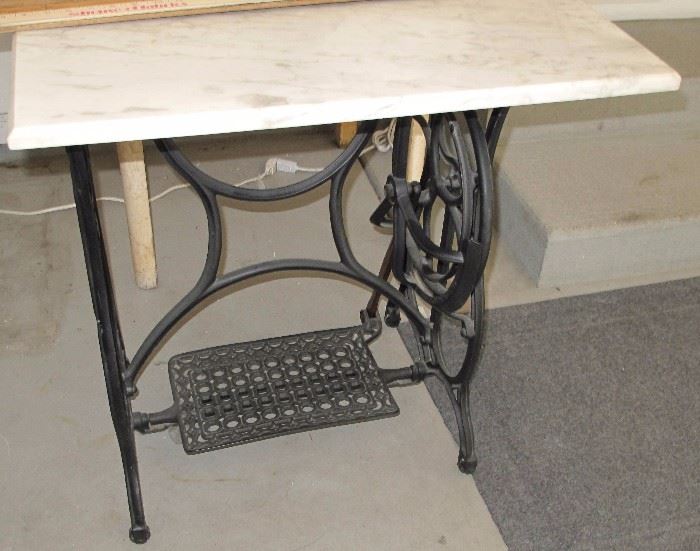 Treadle sewing machine base with marble top.