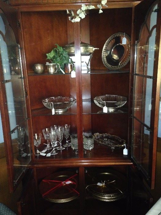 Two-door glass front corner cabinet and serving pieces