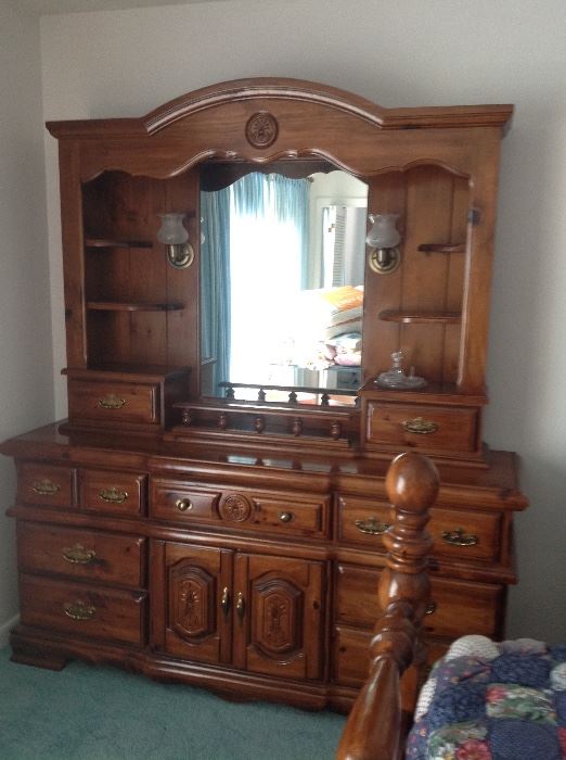 This beautiful dresser and mirror offers plenty of storage for clothes.  There is a light on each side of the mirror.