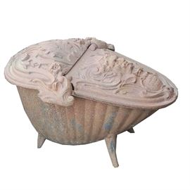 Antique Cast Iron Coal Scuttle: An antique coal scuttle made of cast iron. This 19th century coal scuttle has a cast relief impression of a Satire’s face with foliate and scroll motifs and verbiage that reads “Corneau Freres, A Charleville Ardennes” the foundry mark. It has four peg legs. No maker’s marks present.