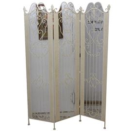 Wrought Iron Trifold Screen: A wrought iron room screen. This three panel screen is made of scrolling and twisted rods of wrought iron. There are torch like finials on the tops of the two side panels and there is a basket weave design to the side of each panel.